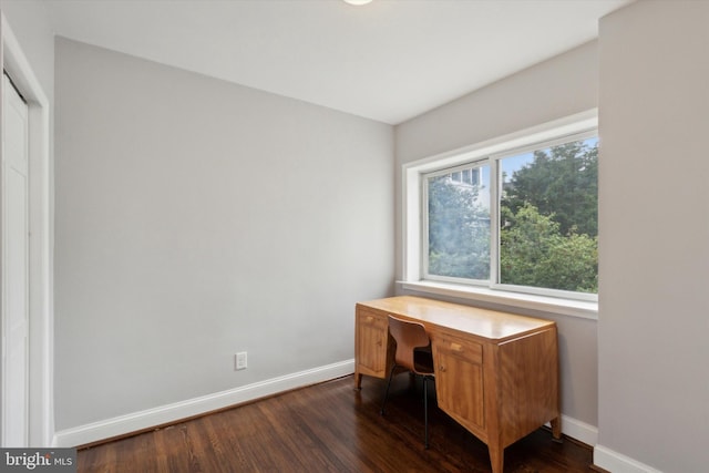 office space with dark wood-type flooring