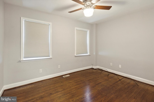 spare room featuring ceiling fan and dark hardwood / wood-style flooring