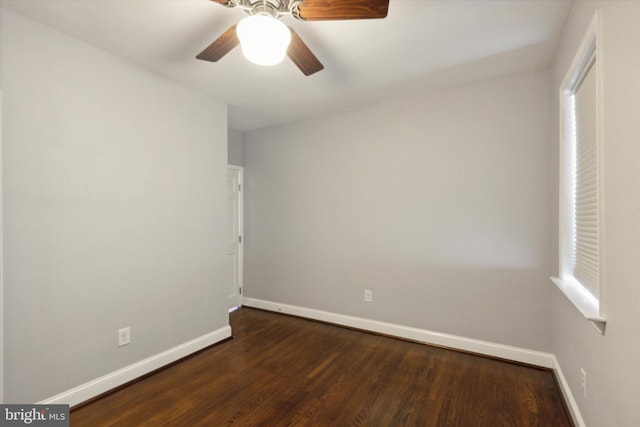 spare room featuring dark hardwood / wood-style flooring and ceiling fan