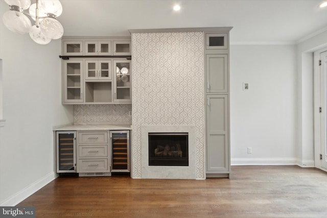 bar with ornamental molding, wine cooler, and dark hardwood / wood-style floors