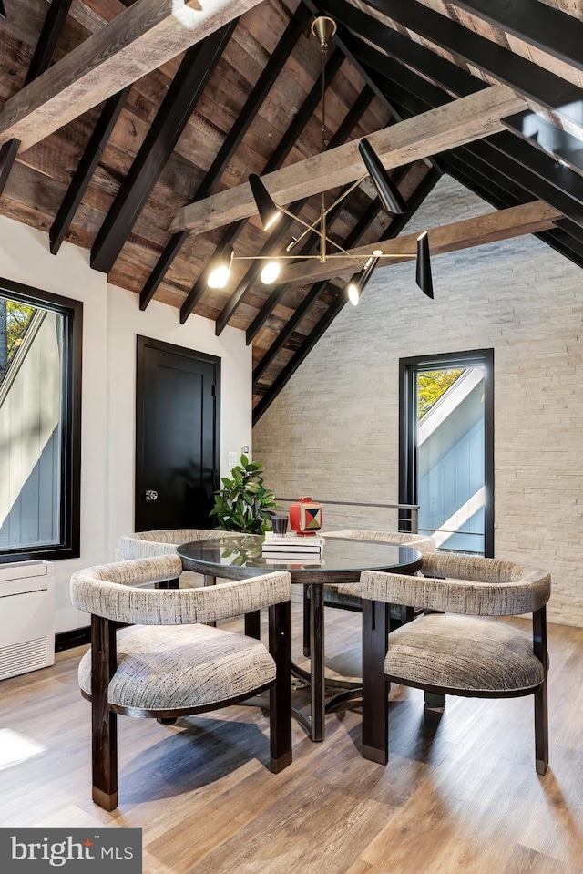 interior space featuring beam ceiling, light hardwood / wood-style flooring, high vaulted ceiling, and wooden ceiling