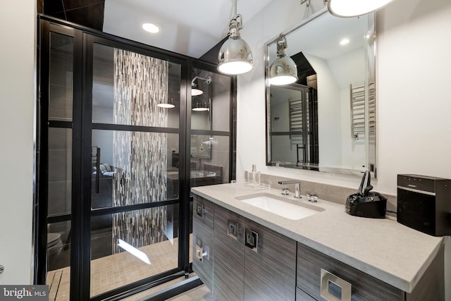 bathroom featuring tile patterned flooring, vanity, and toilet