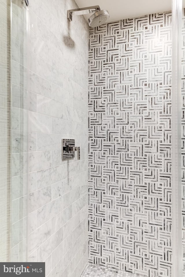 bathroom with a tile shower