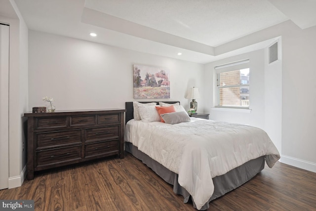 bedroom with dark wood-type flooring