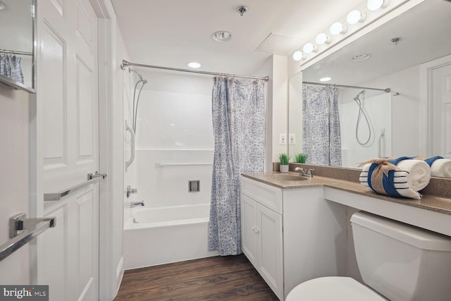 full bathroom with vanity, hardwood / wood-style floors, toilet, and shower / bath combo