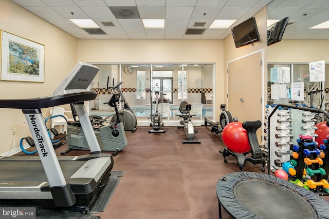 exercise room featuring a paneled ceiling