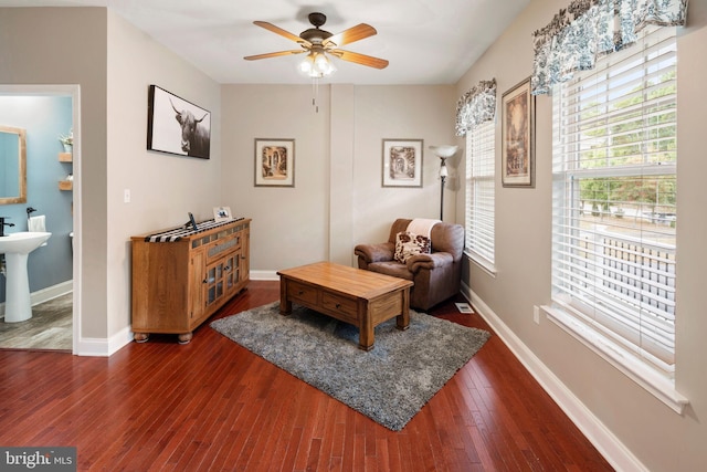 sitting room with ceiling fan, sink, and dark hardwood / wood-style floors