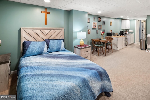 carpeted bedroom featuring a paneled ceiling