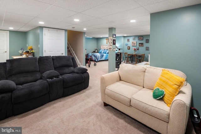 living room featuring a paneled ceiling and light carpet