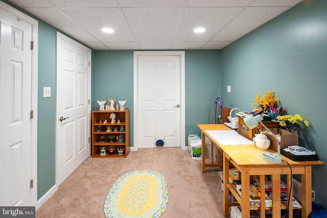 office space with a drop ceiling and light colored carpet