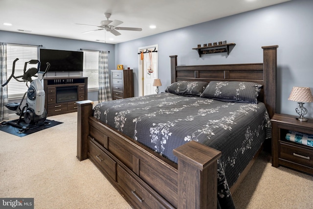 bedroom featuring light carpet and ceiling fan