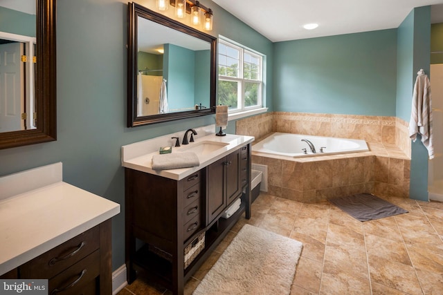 bathroom with vanity and separate shower and tub