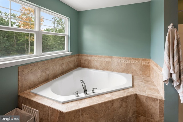 bathroom featuring tiled tub