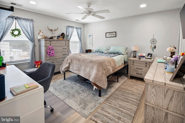 bedroom with light hardwood / wood-style flooring and ceiling fan