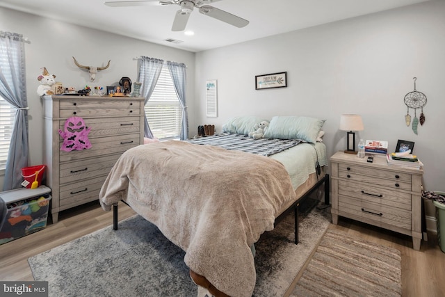 bedroom with ceiling fan and light wood-type flooring