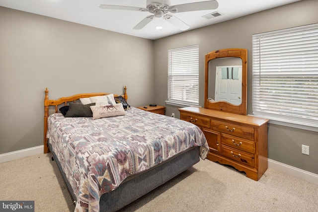 bedroom featuring light carpet and ceiling fan