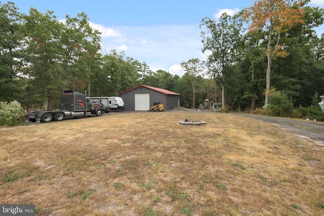 view of yard featuring an outbuilding and a garage