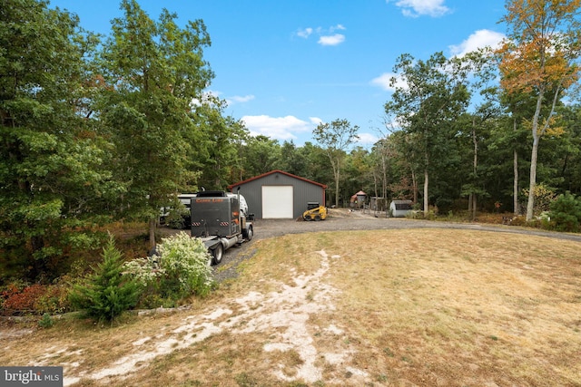 view of yard with a garage and an outdoor structure