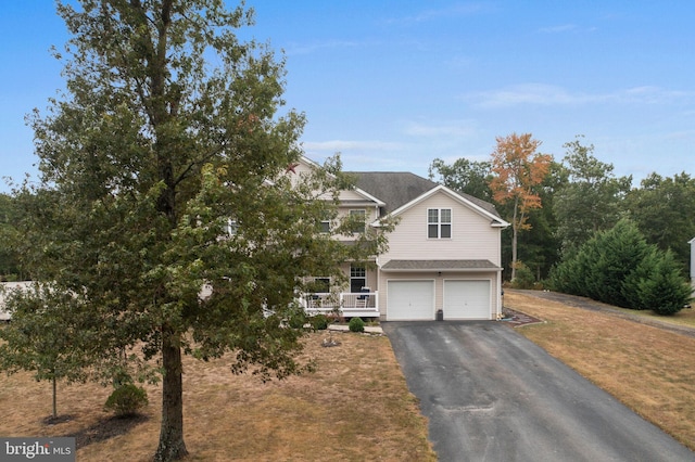 view of front facade with a garage and covered porch