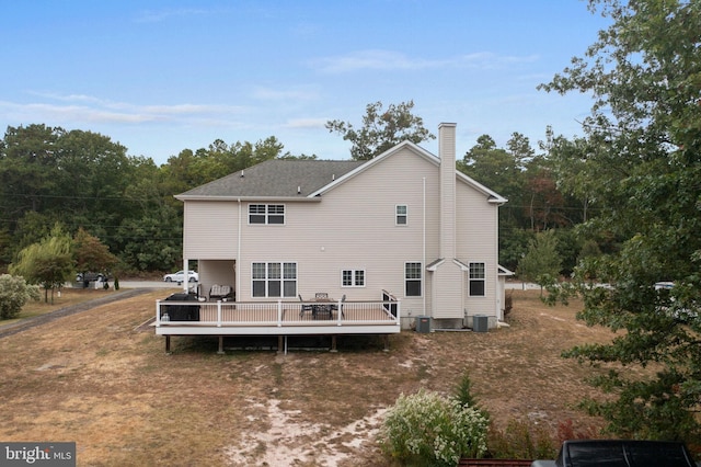 back of property featuring cooling unit and a deck