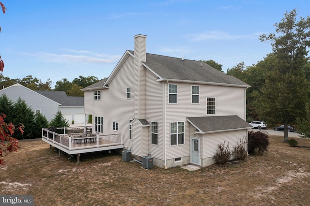 rear view of house with central air condition unit and a wooden deck