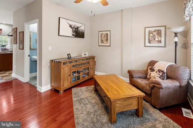 sitting room with dark hardwood / wood-style flooring and ceiling fan