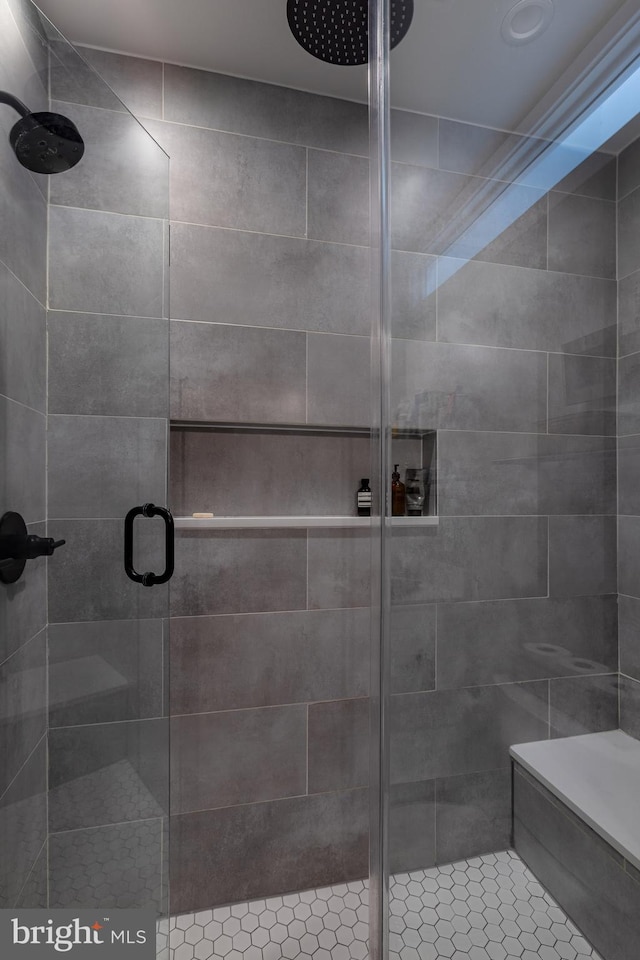 bathroom featuring walk in shower and tile patterned flooring