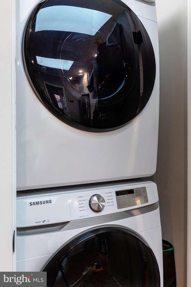 laundry room with stacked washer and dryer