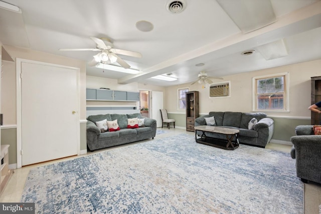 living room with beam ceiling, ceiling fan, and light hardwood / wood-style flooring