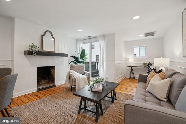 living room with a fireplace and hardwood / wood-style flooring