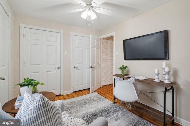 home office with ceiling fan and hardwood / wood-style floors