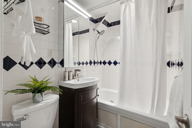 full bathroom featuring vanity, tile walls, shower / bath combo with shower curtain, and toilet