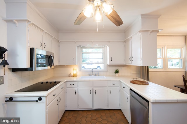 kitchen with white cabinetry, stainless steel appliances, and sink