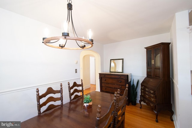 dining space featuring a notable chandelier and wood-type flooring