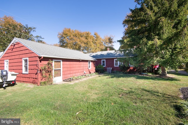 view of property exterior featuring a yard and central AC unit