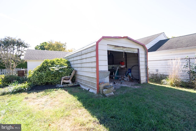 view of outbuilding with a lawn