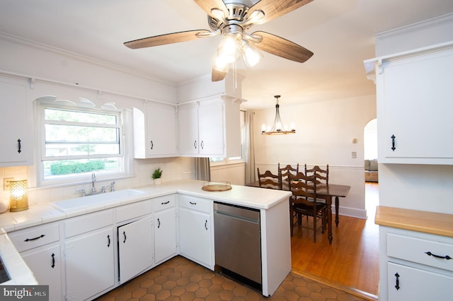 kitchen with tasteful backsplash, white cabinetry, dishwasher, decorative light fixtures, and sink