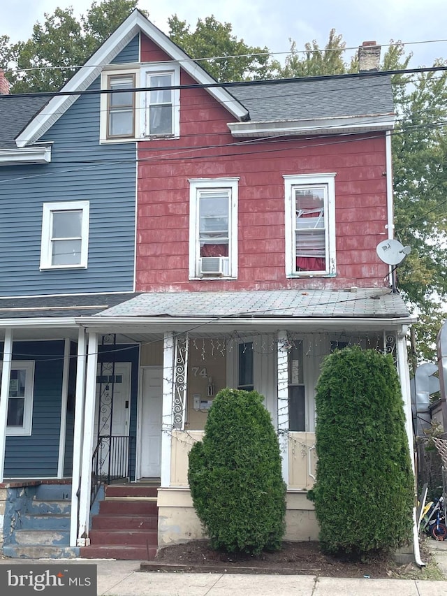 view of front facade with cooling unit and covered porch