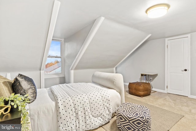 carpeted bedroom featuring vaulted ceiling