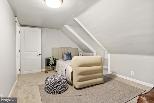 bedroom featuring light carpet and vaulted ceiling