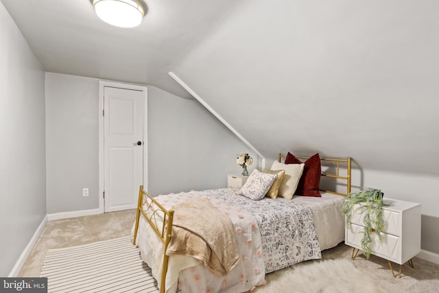 carpeted bedroom with vaulted ceiling