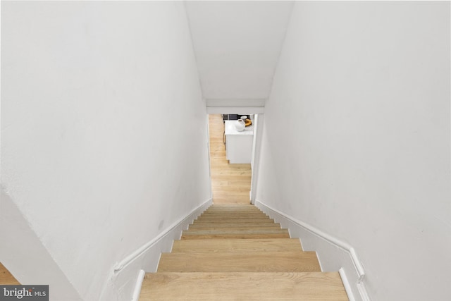 stairway featuring hardwood / wood-style flooring