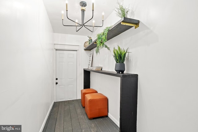 interior space with a chandelier and dark hardwood / wood-style floors