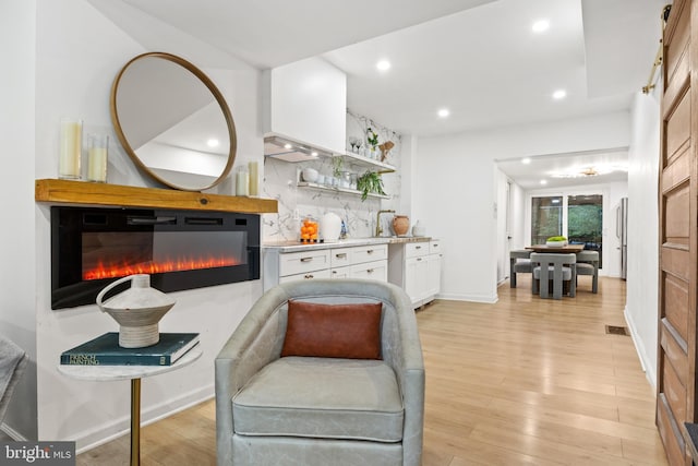 sitting room featuring light hardwood / wood-style flooring