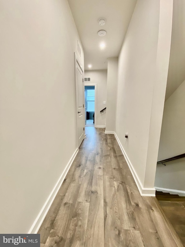 hall with light hardwood / wood-style flooring