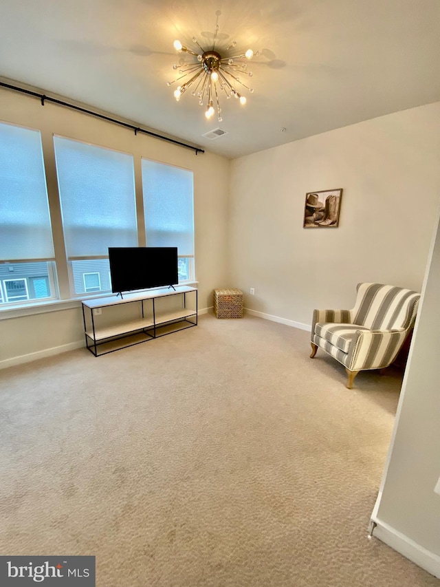 living area featuring carpet floors and an inviting chandelier