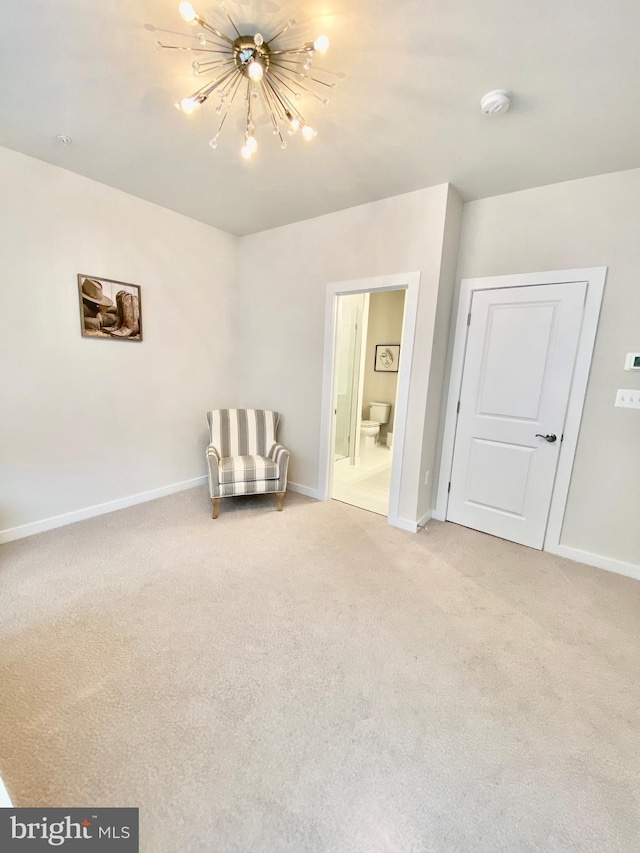 unfurnished room with light carpet and a notable chandelier