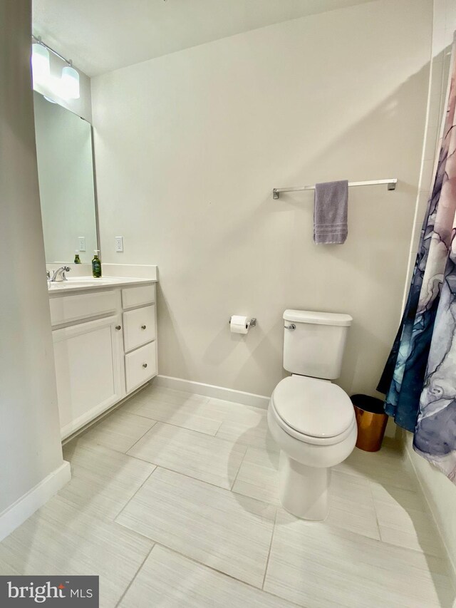 bathroom with tile patterned floors, vanity, and toilet