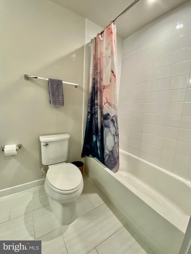 bathroom featuring shower / bath combo and toilet