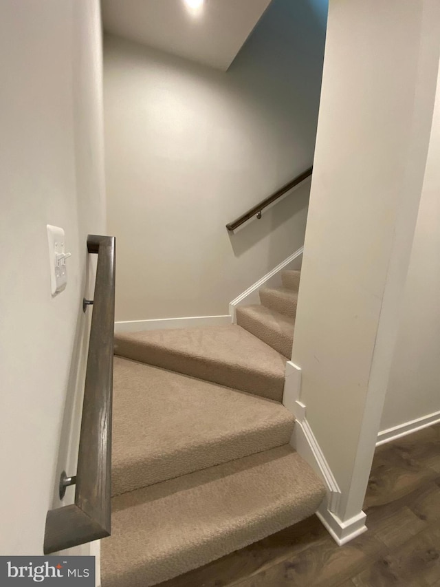 stairway featuring hardwood / wood-style flooring